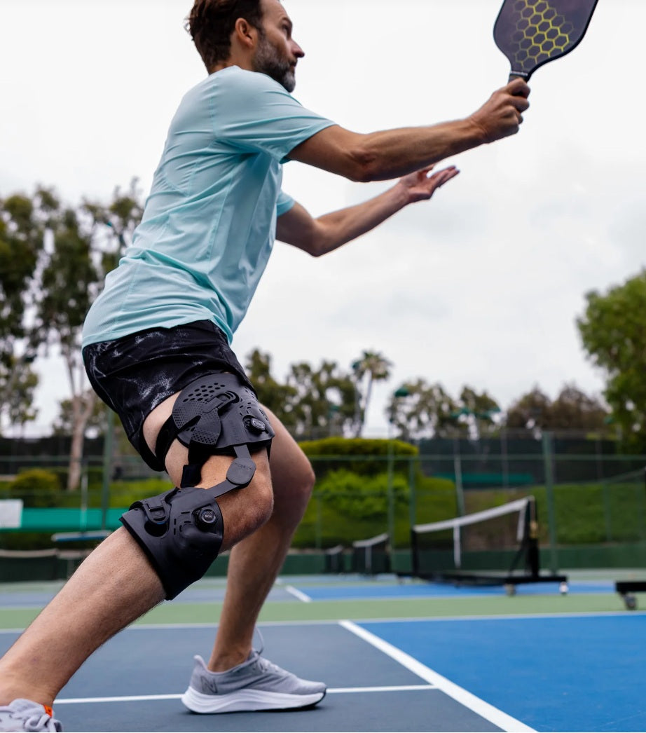 Active adult wearing an Ossur Unloader One X knee brace during pickleball