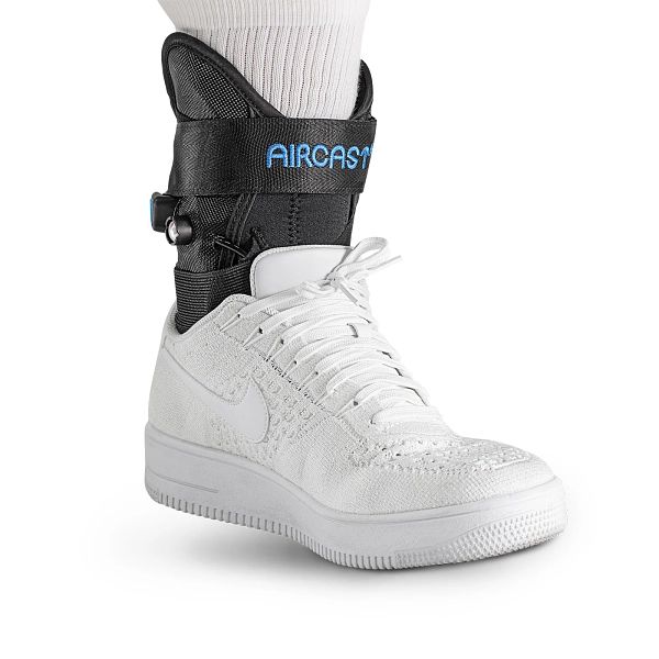 White sneaker with an Aircast AirLift adult acquired flatfoot brace with integrated inflation system on a white background